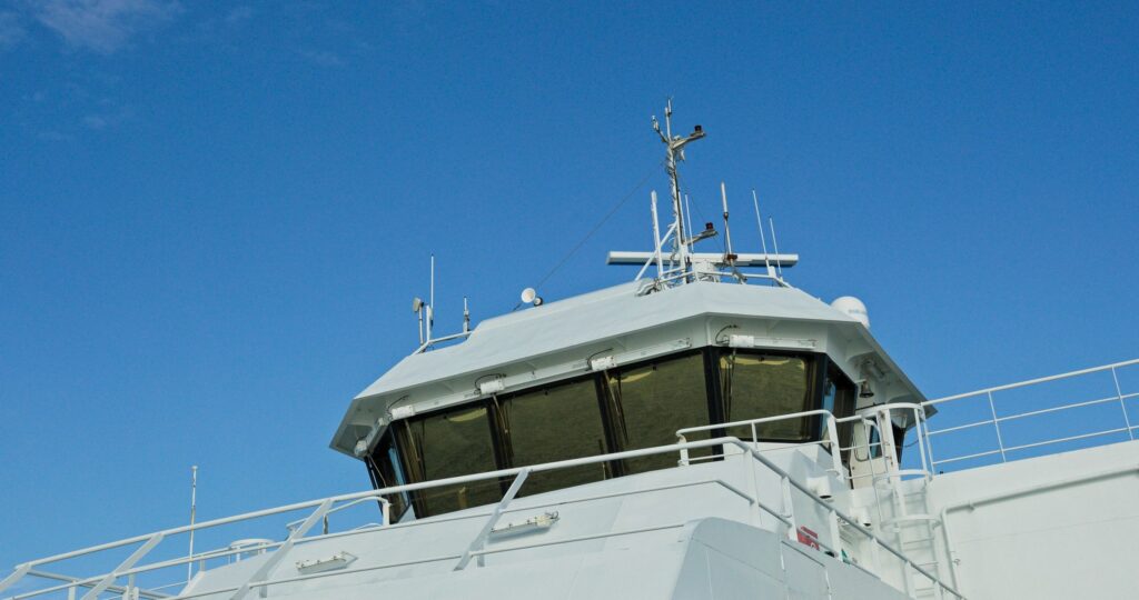 Ship's bridge navigating under clear blue sky in norway